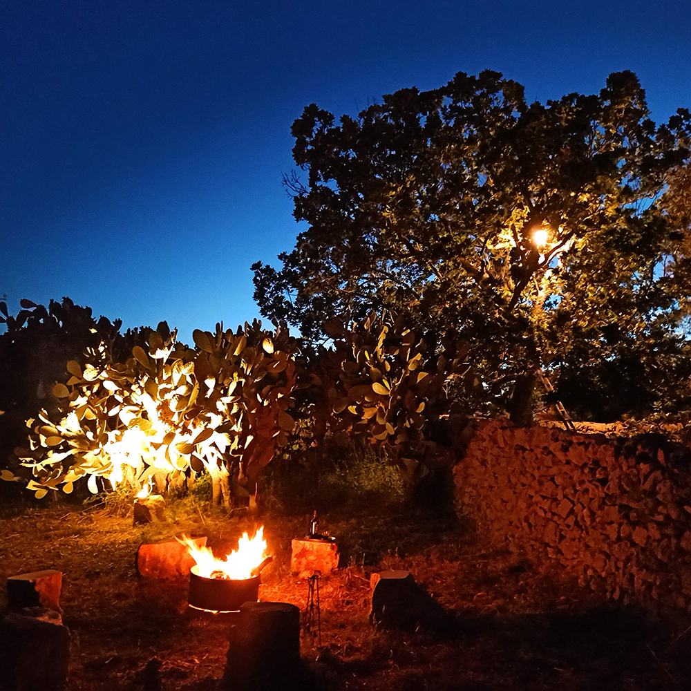 The evening fire, in a ring of stones