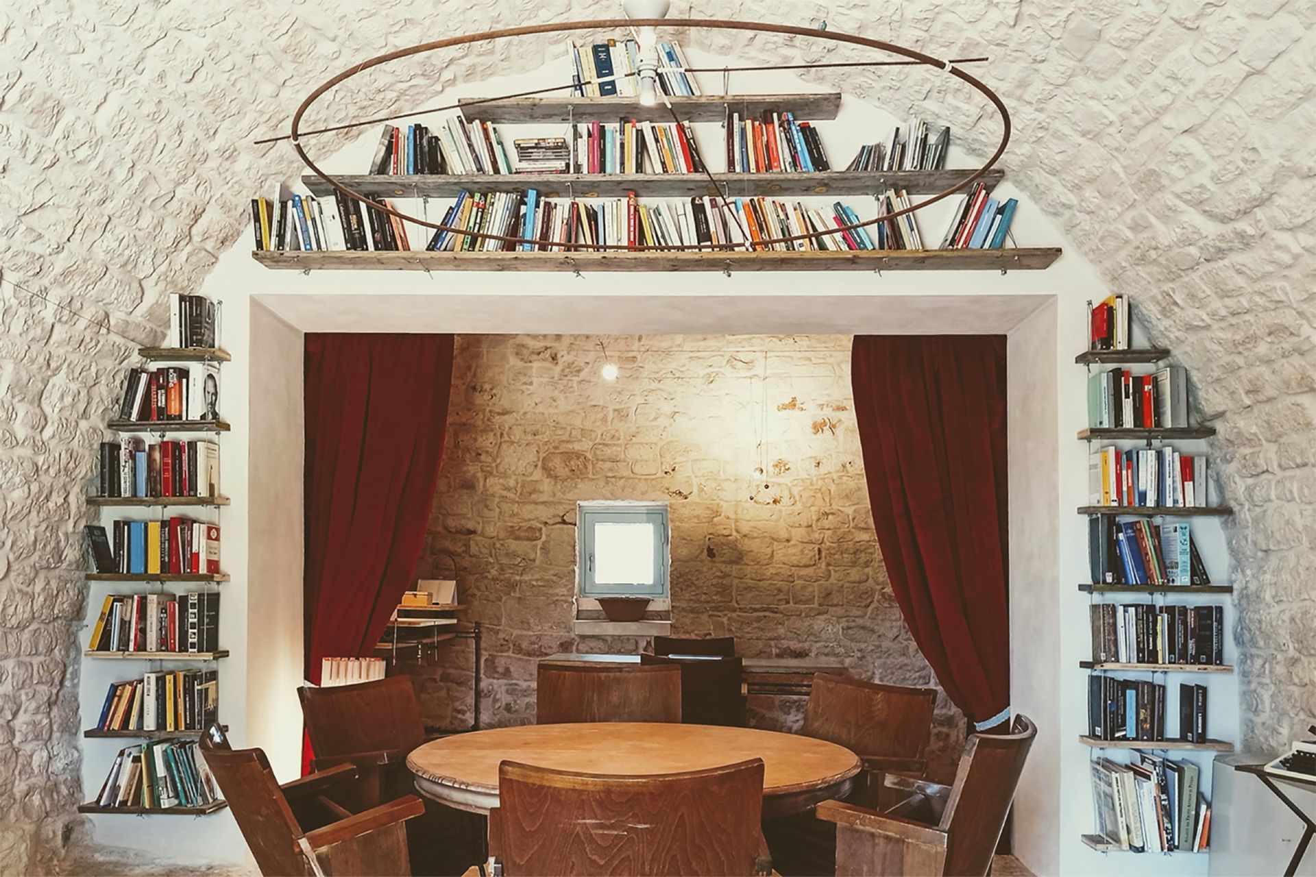 Il Focolare: il sipario rosso e la biblioteca nel boccascena