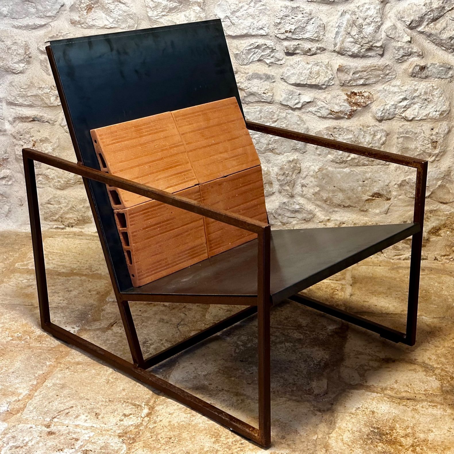 REVENANT, an armchair of iron, sheet metal and brick